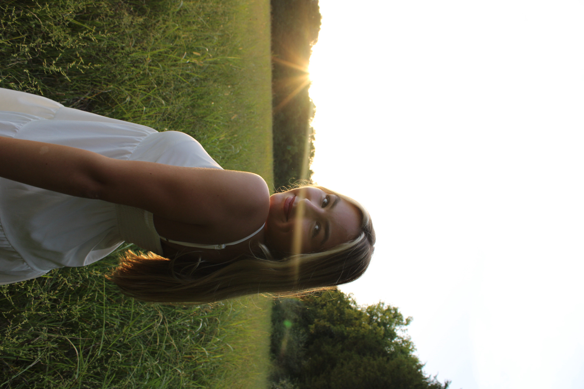 Backlit portrait in a summer field at sunset